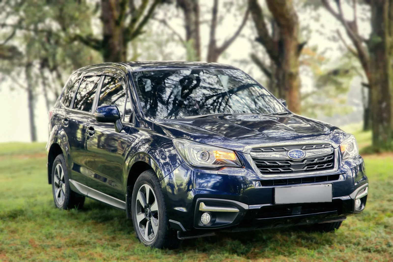 Subaru Forester, front three-quarter from the right with its lights on