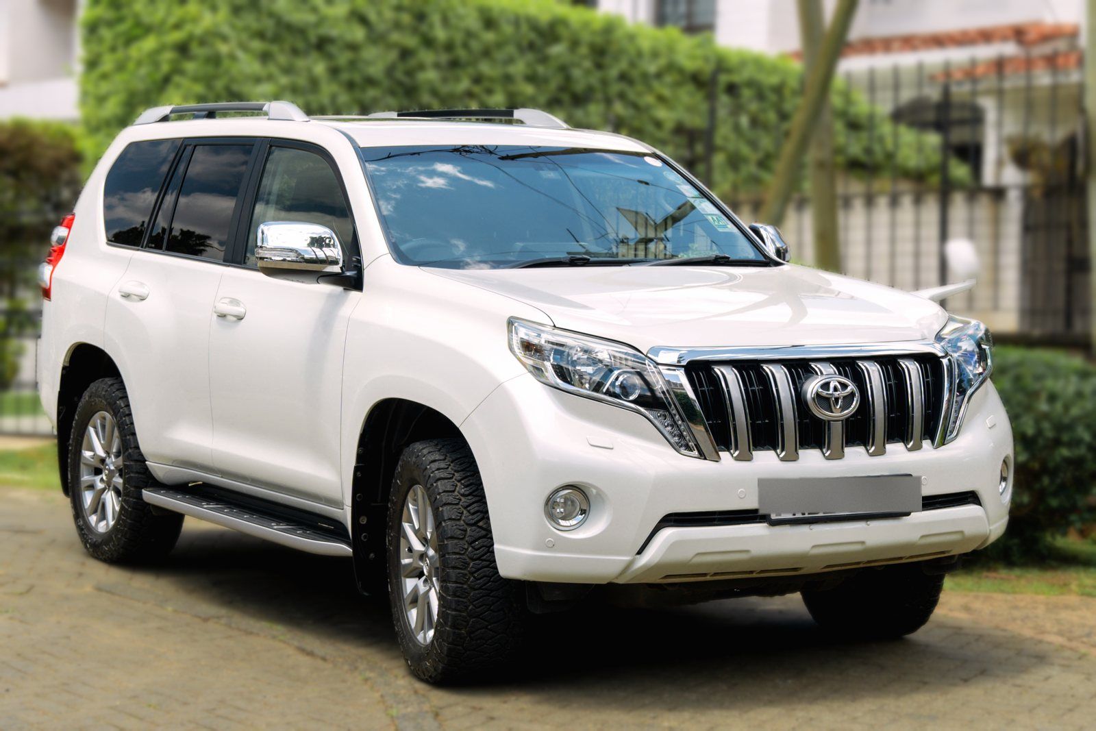 White Toyota Land Cruiser Prado TX arriving at the gate of a Nairobi home