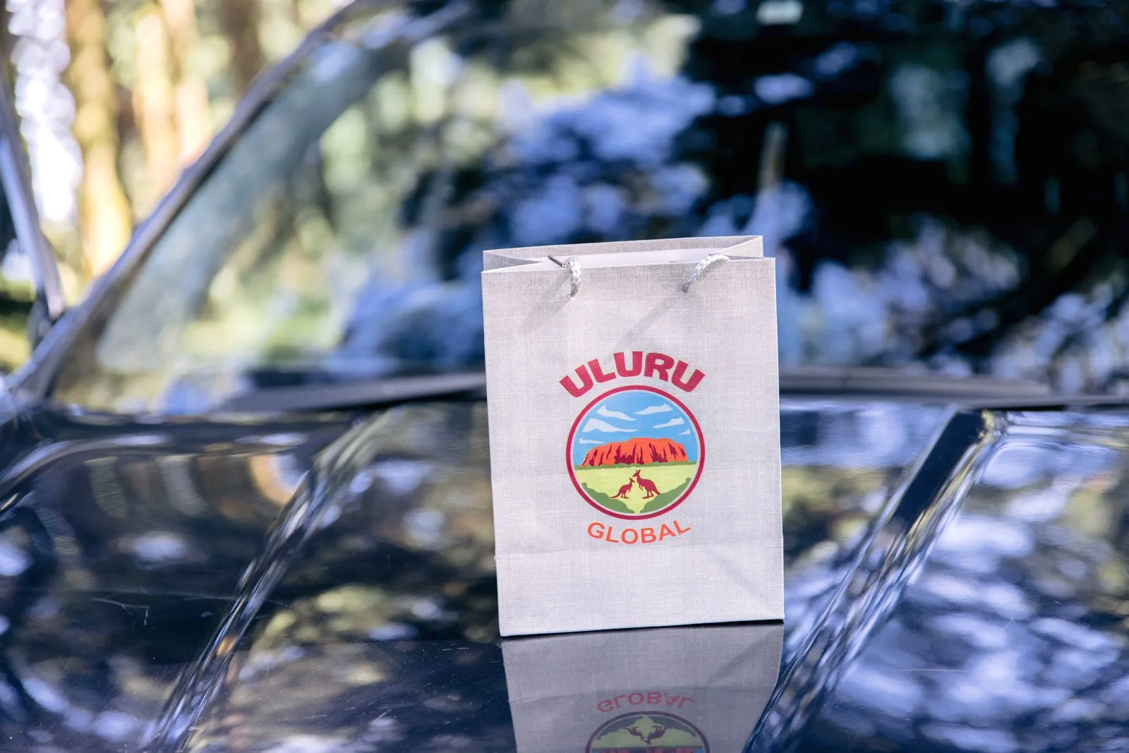 Uluru Global welcome bag on a car bonnet